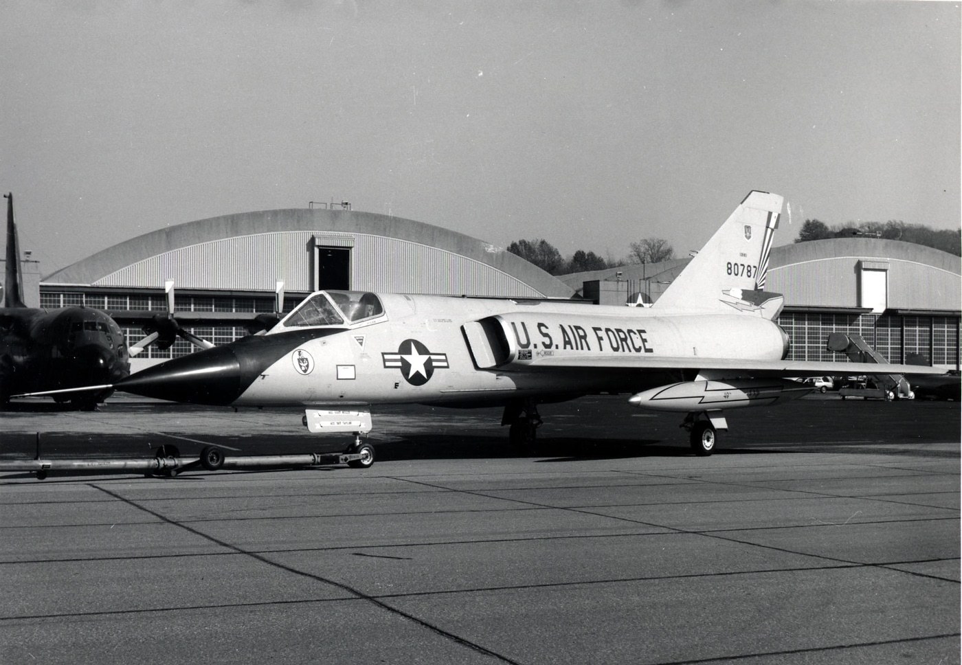 Black-and-white side view of Convair F-106 Delta Dart 80787 parked on a ramp.