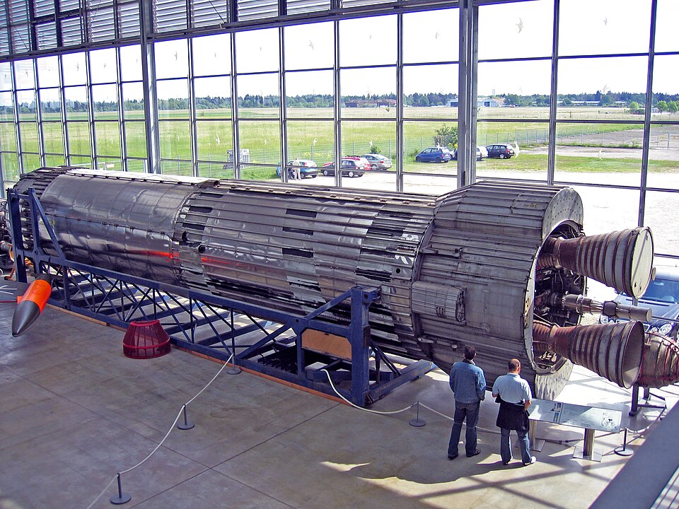 Blue Streak missile displayed indoors with support equipment around it, showing de Havilland's missile and rocket work beyond aircraft production.