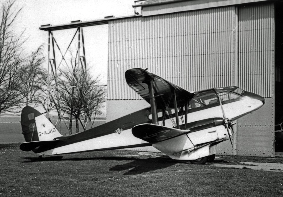 de Havilland DH.89A Dragon Rapide on the ground, showing the twin-engine biplane airliner with its enclosed cabin and fabric-covered wings.