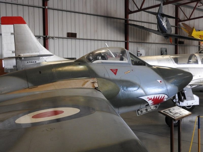 de Havilland Vampire displayed indoors with shark-mouth nose art.