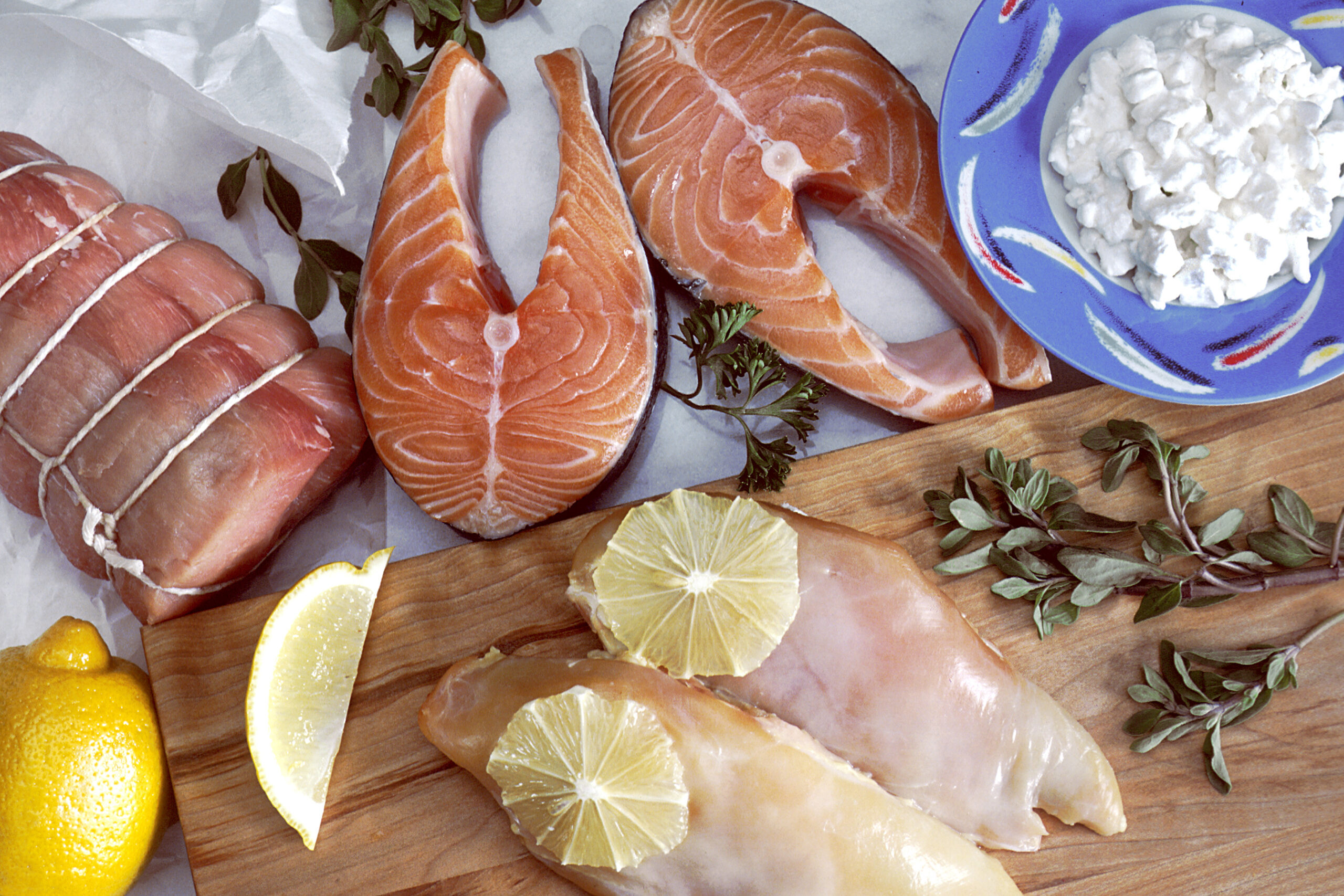Meat, fish, and dairy foods on a display board