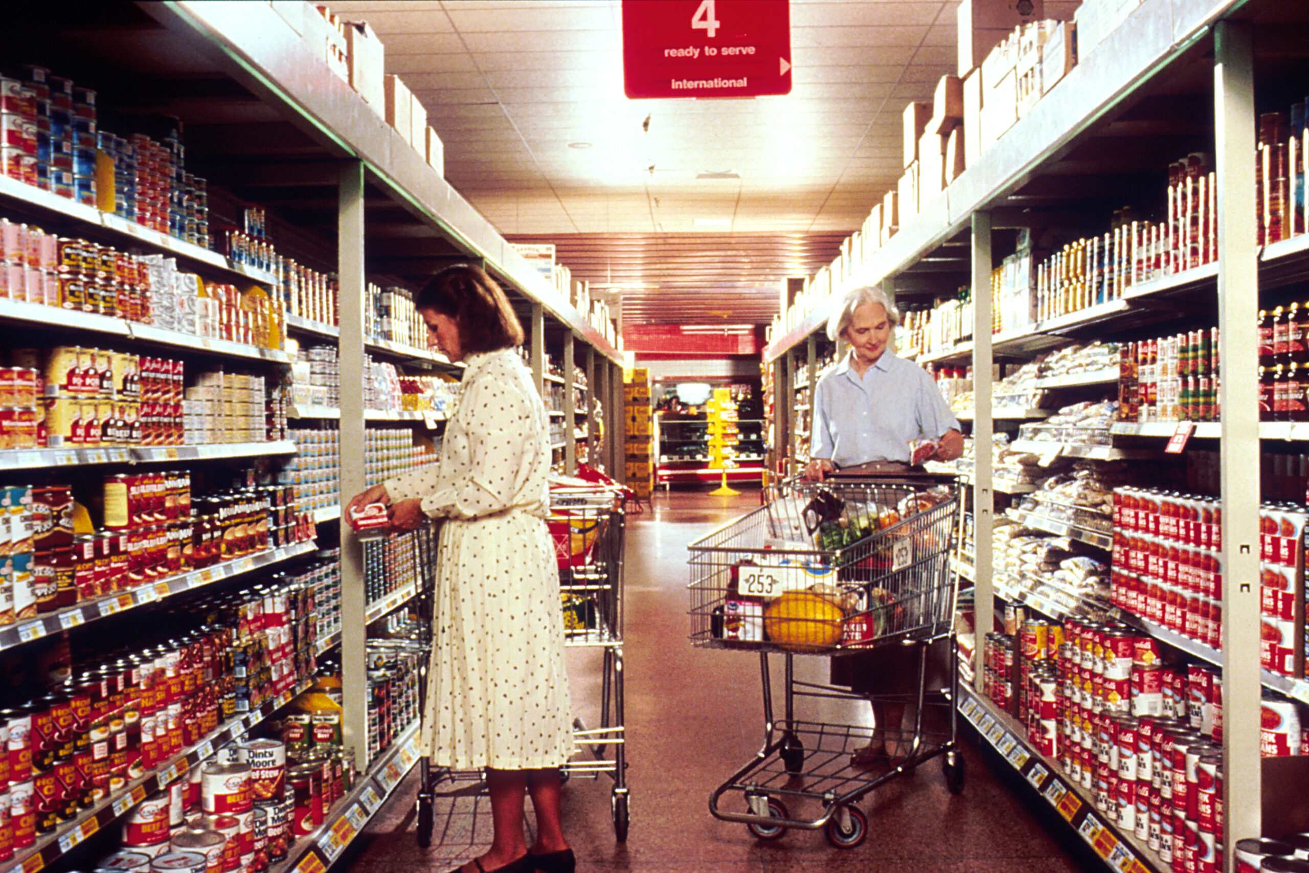 People shopping in a grocery store aisle