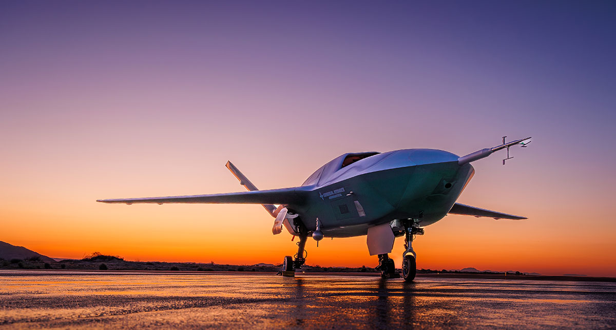 Dark GA-ASI unmanned aircraft standing on landing gear at sunset