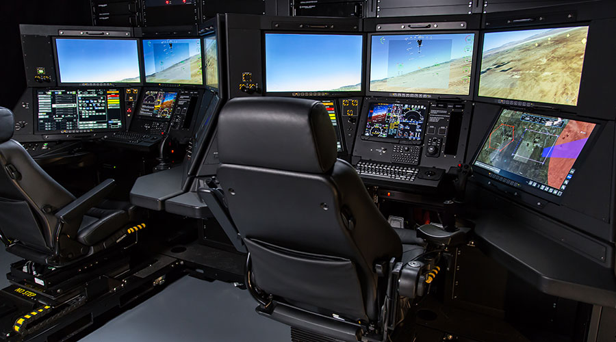 GA-ASI ground control station consoles with display screens and operator seats