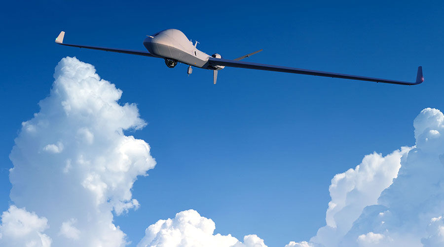 Gray GA-ASI remotely piloted aircraft flying above clouds