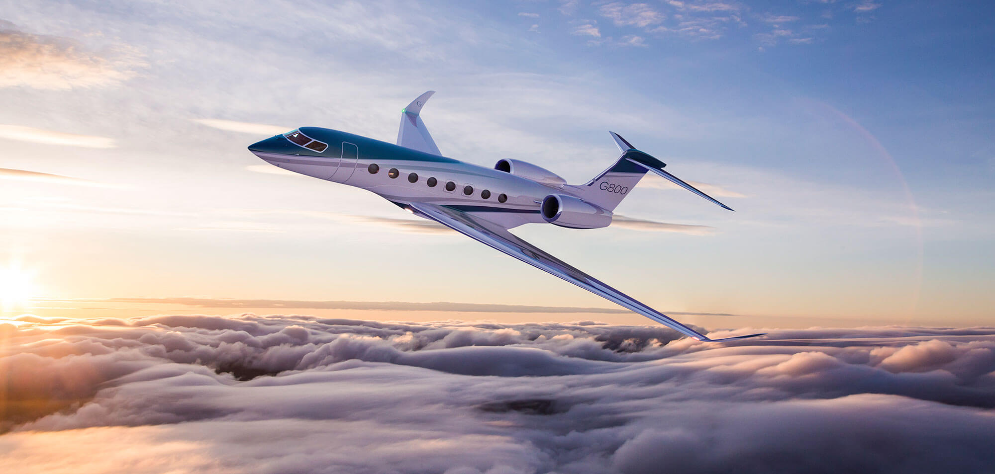 White Gulfstream G800 business jet flying above clouds