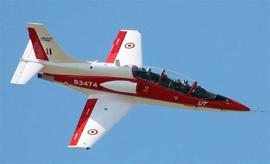 HAL HJT-36 Sitara red and white aircraft banking against blue sky