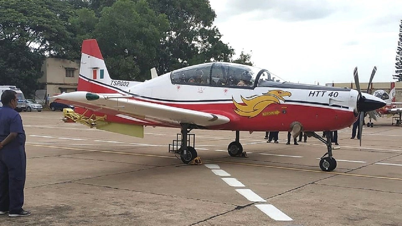 HAL HTT-40 red and white trainer aircraft on the ground