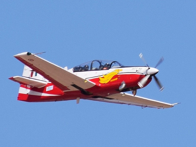 HAL HTT-40 trainer banking in flight against blue sky