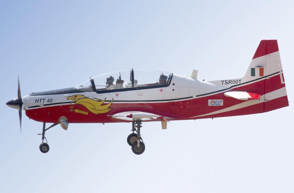 HAL HTT-40 red and white trainer aircraft in flight side view