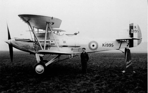 Black-and-white side view of Hawker Audax K1995 parked on grass.