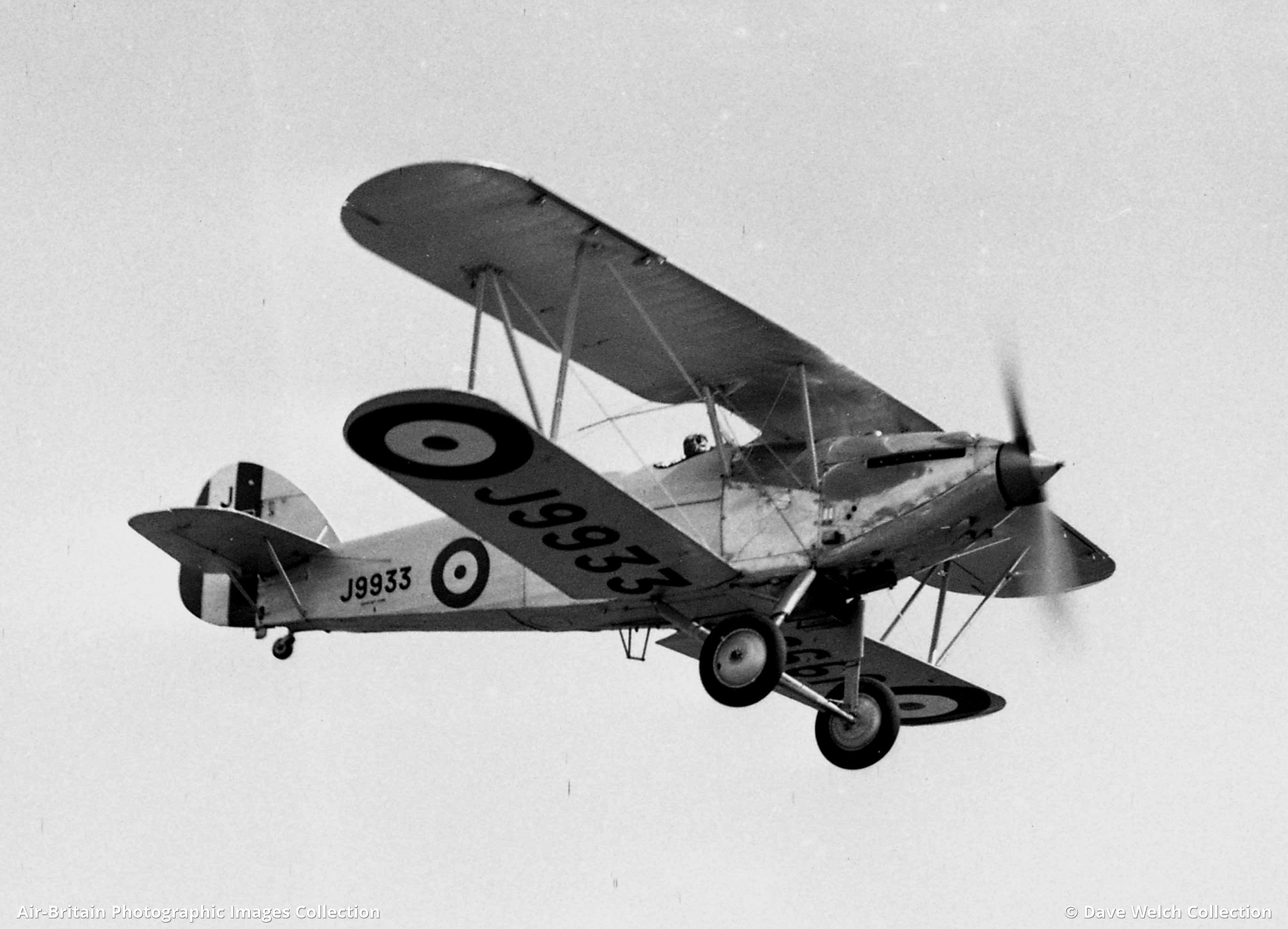 Black-and-white close view of Hawker Hart J9933 showing wing, struts, cockpit, and wheel.