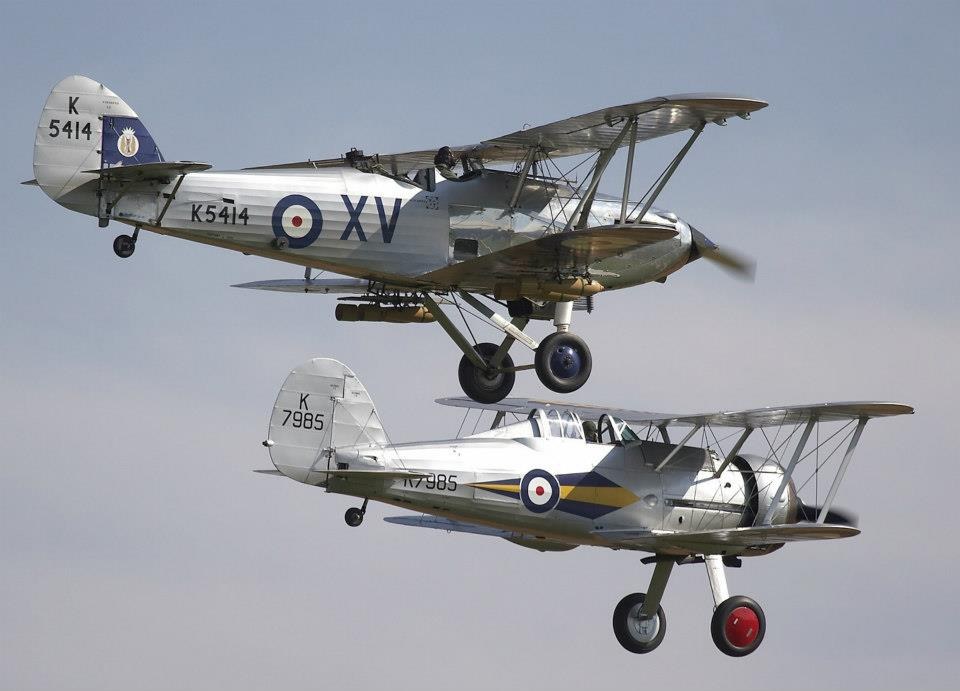 Two silver RAF biplanes marked K5414 and K7985 flying together.