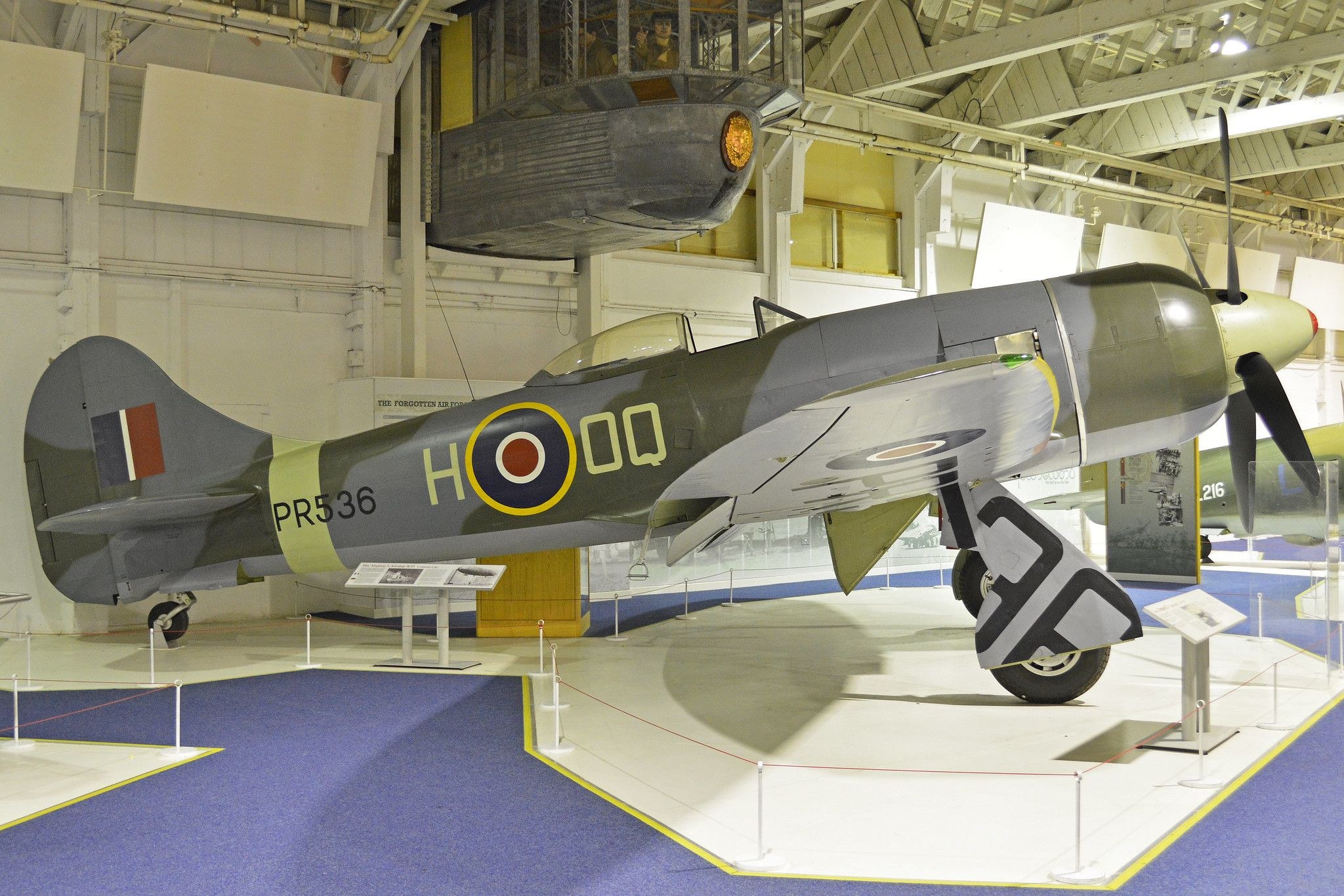 Camouflaged Hawker Tempest PR536 displayed indoors with RAF roundels.