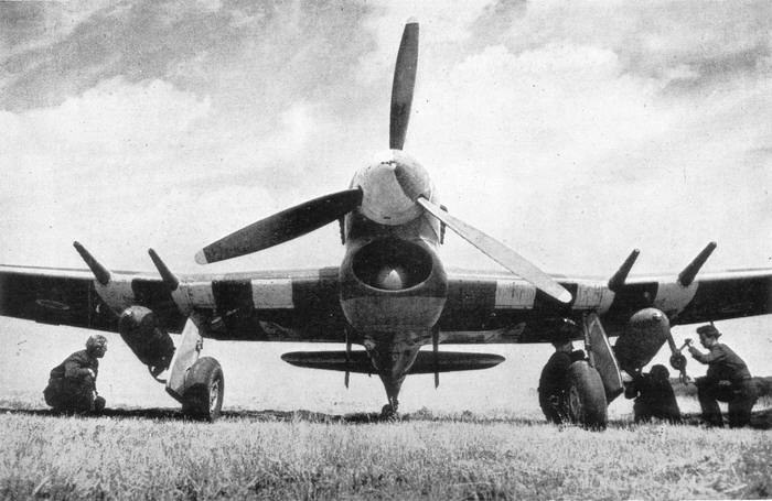 Black-and-white front view of a Hawker Typhoon on grass with crew near the wings.