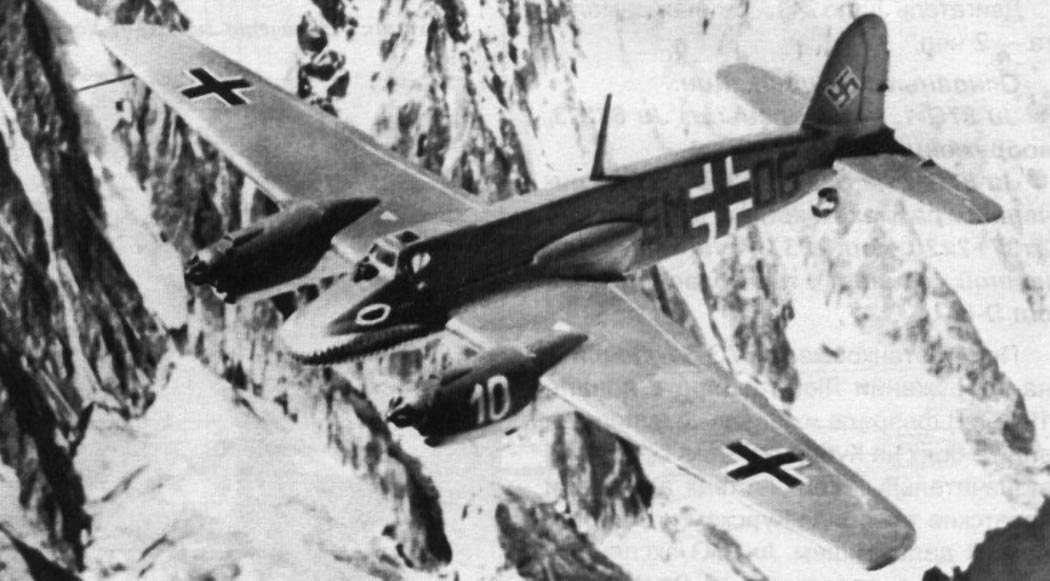 Henschel Hs 129 ground-attack aircraft banking over mountains