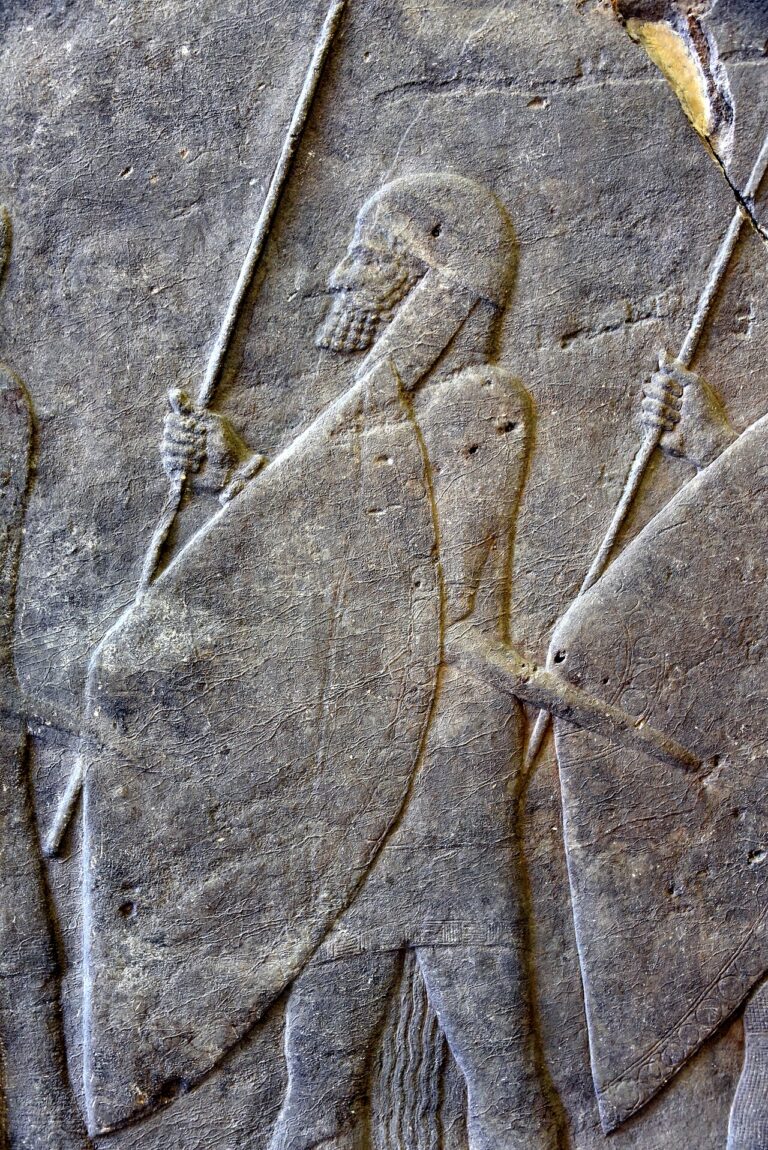 Alabaster bas relief, procession of Assyrian warriors, reign of Sennacherib, from Nineveh, Iraq. 7th century BCE. Pergamon Museum, Berlin