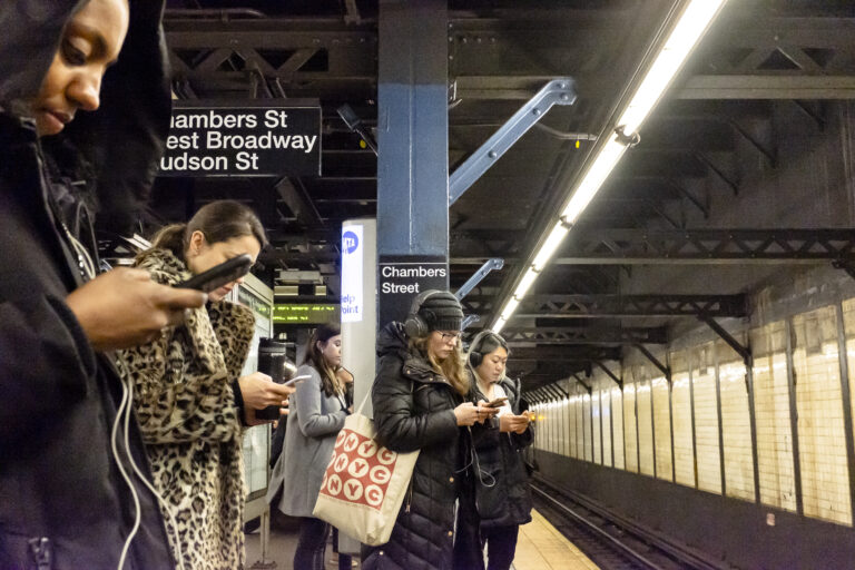 Commuters on smartphones at Chambers Street