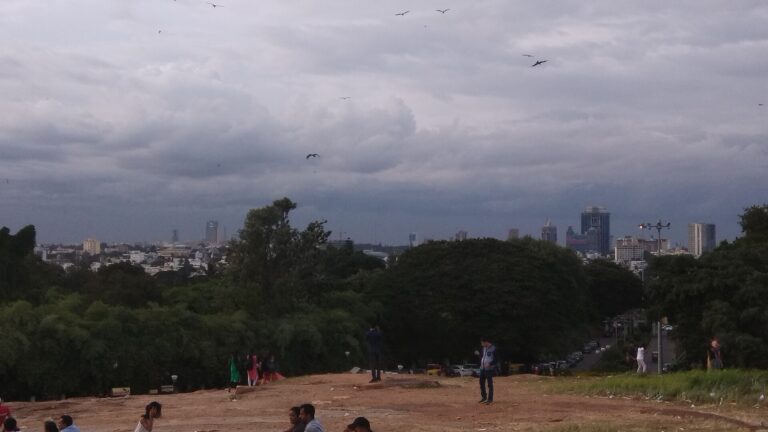 Bangalore skyline beyond an open hilltop