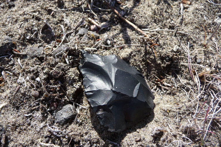 Obsidian blade on sandy ground