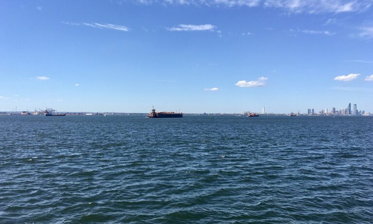 Jersey City skyline and container ships from Rockaway Ferry, New York Harbor