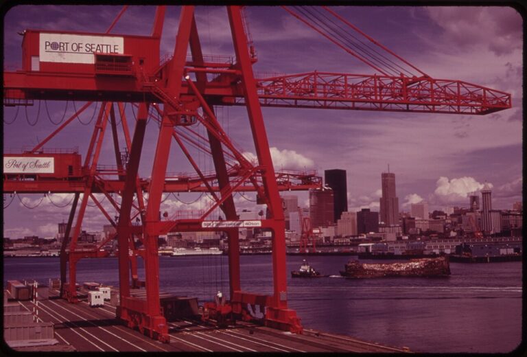 PORT OF SEATTLE FREIGHT HANDLING EQUIPMENT AND CITY SKYLINE FRAMES INDUSTRIAL WASTE BARGE UNDER TOW TO LANDFILL ON THE SNOHOMISH RIVER ESTUARY
