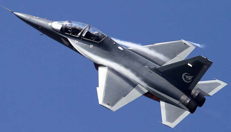 Dark Hongdu L-15 Falcon trainer climbing against blue sky