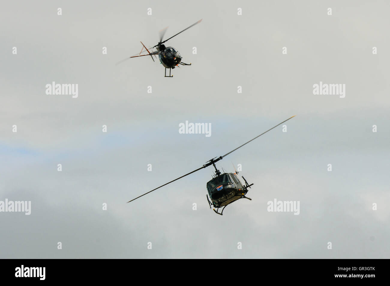 Hughes OH-6 Cayuse - Bell UH-1 Iroquois "Huey" helicopter, followed by a Hughes OH-6 Cayuse