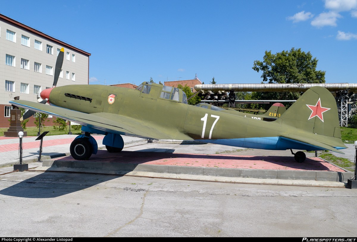 Green Ilyushin Il-10 number 17 displayed outdoors on a paved base.