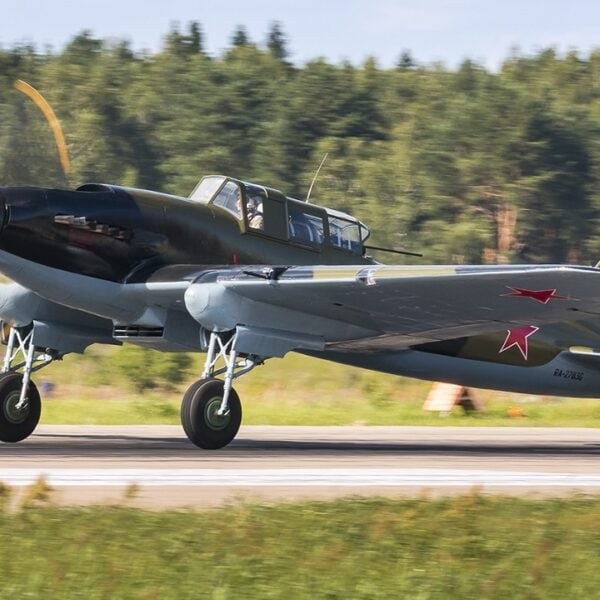 Ilyushin Il-2 Shturmovik moving on a runway with Soviet red stars visible.