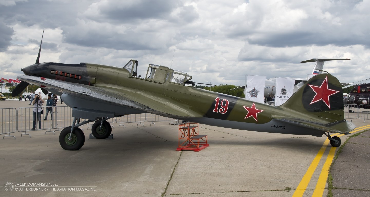 Green Ilyushin Il-2 number 19 parked at an outdoor aircraft display.