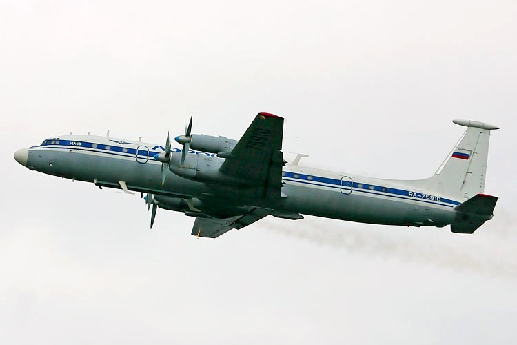 Four-prop Ilyushin Il-22M in flight with blue cheatline and Russian tail flag.