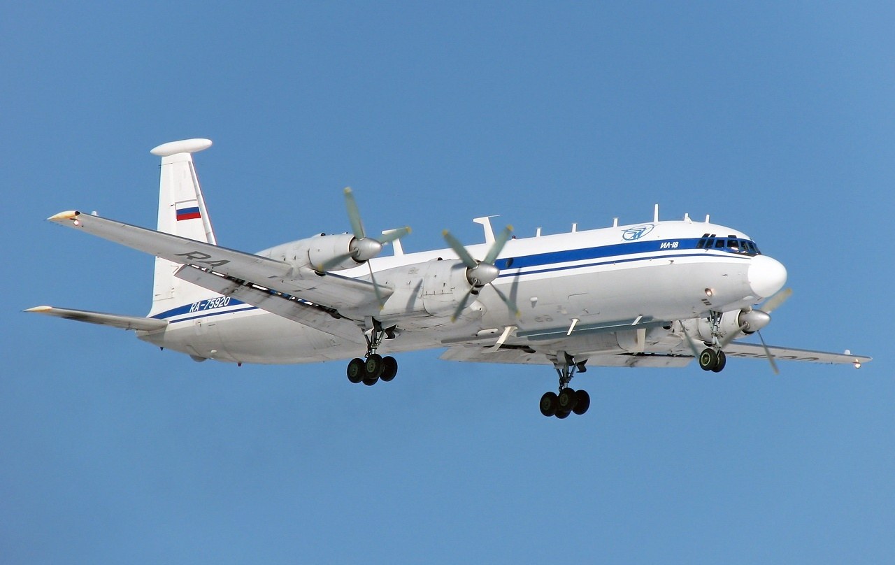 Ilyushin Il-22M RA-75920 flying with landing gear down and Russian flag on the tail.