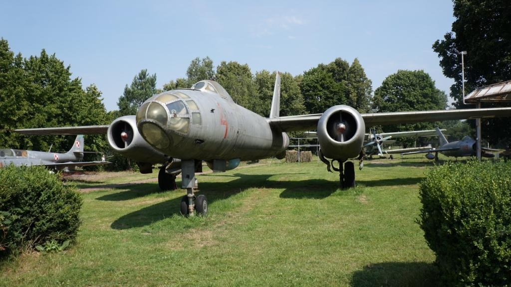 Front view of a grey Ilyushin Il-28 parked outdoors with twin jet intakes and glazed nose.