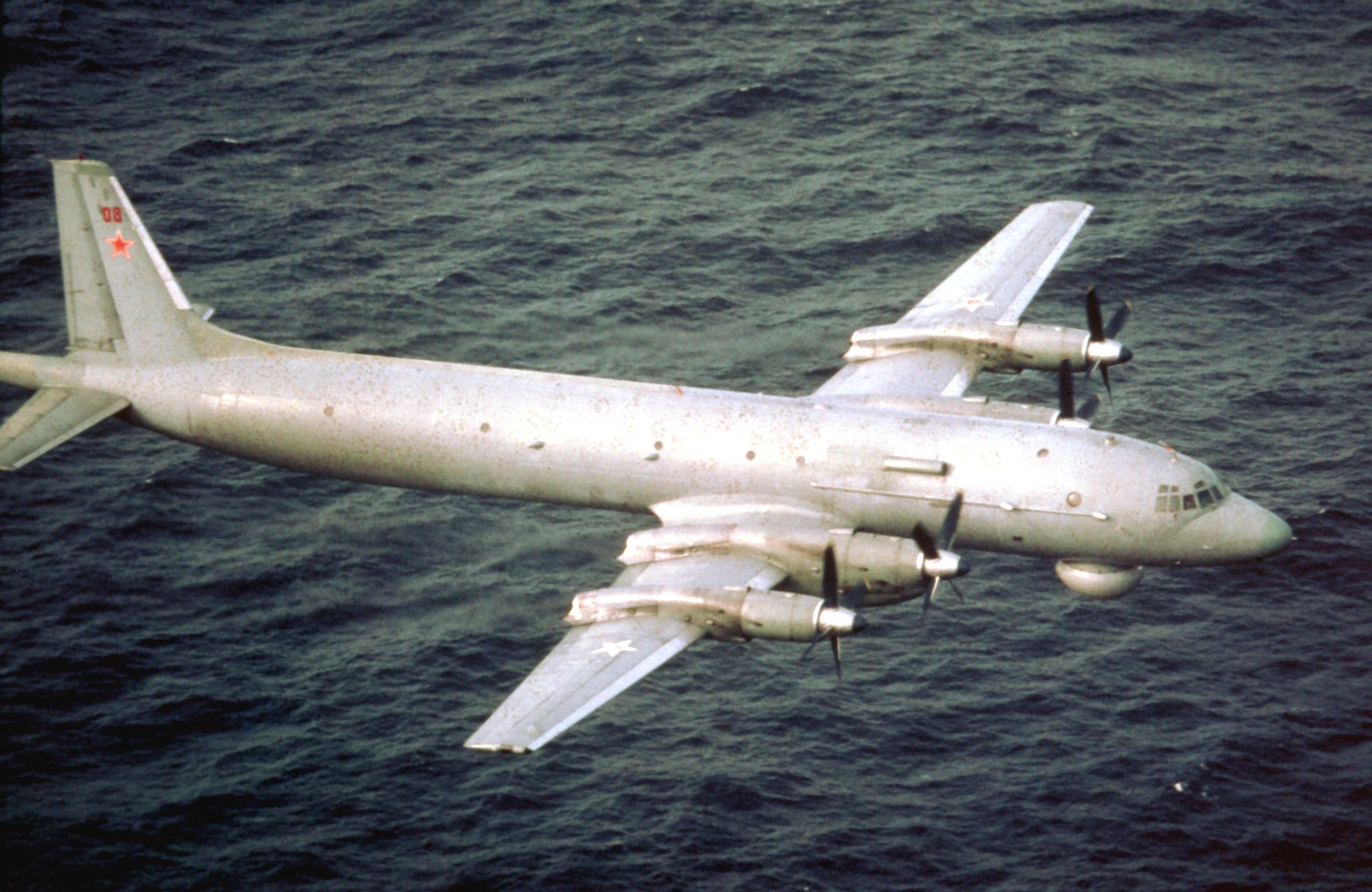 Grey Ilyushin Il-38 marked red 08 flying over open water.
