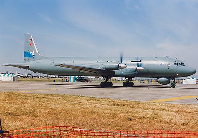 Grey Ilyushin Il-38 taxiing or rolling on a runway with four turboprops.