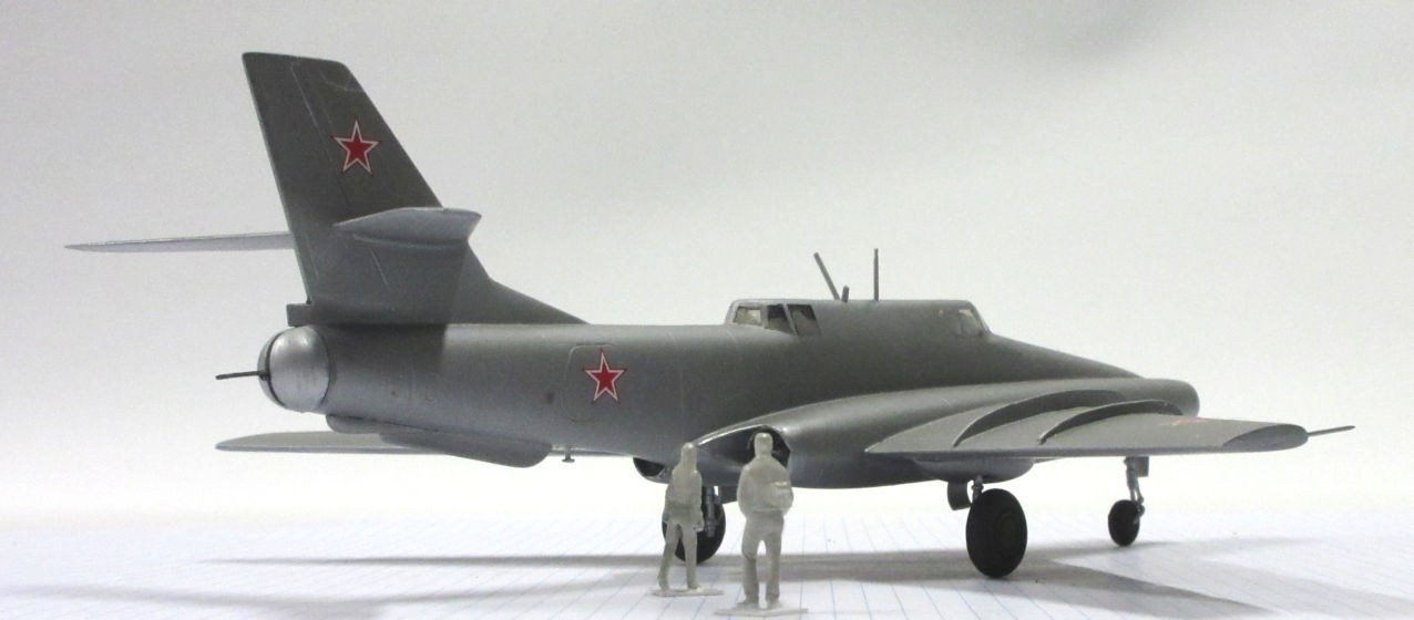 Side view of a grey Ilyushin Il-40 scale model with red star markings and landing gear down.
