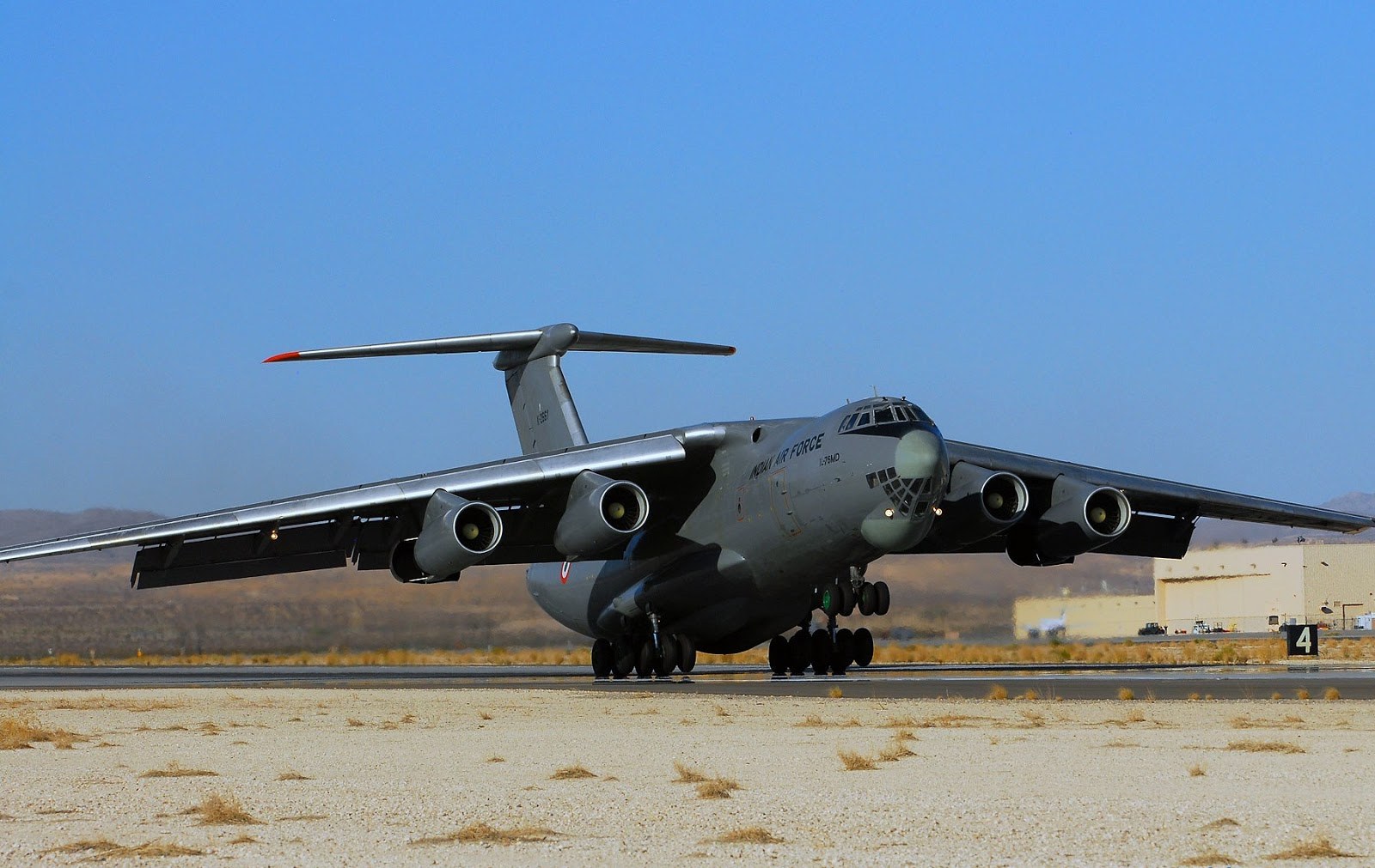 Indian Air Force Ilyushin Il-76 rolling on a runway with landing lights on.