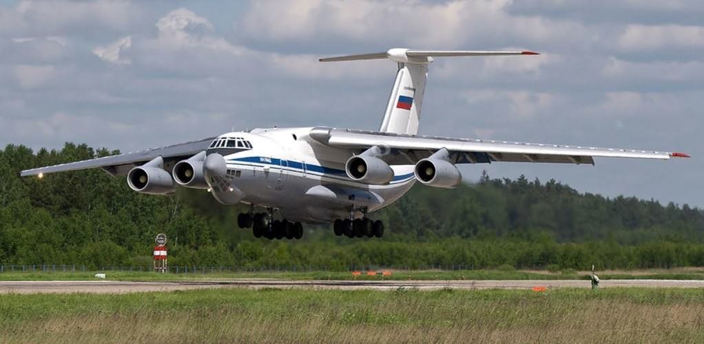 White and blue Ilyushin Il-76 approaching a runway with landing gear extended.