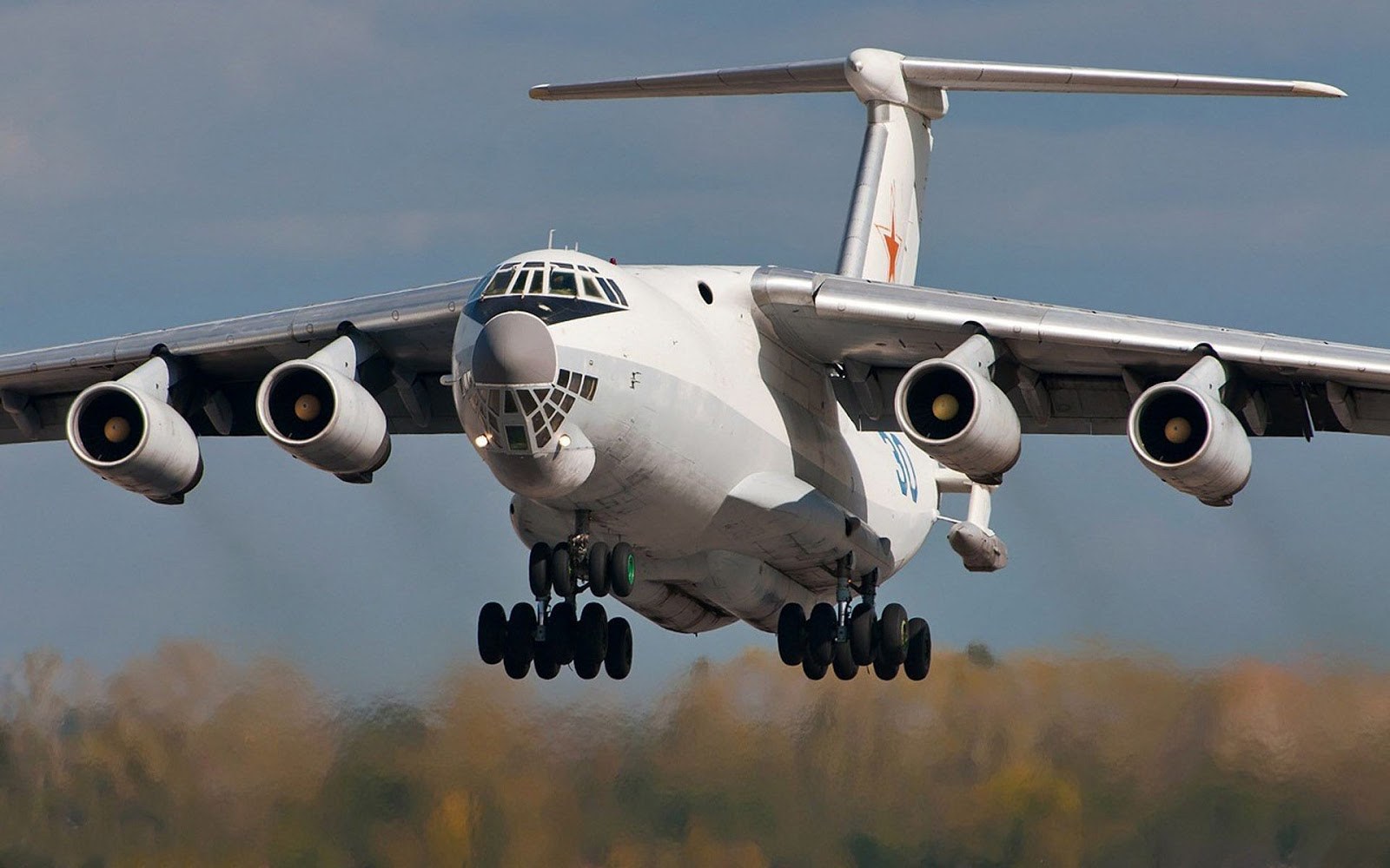 Ilyushin Il-78 approaching with red star tail marking and landing gear down.
