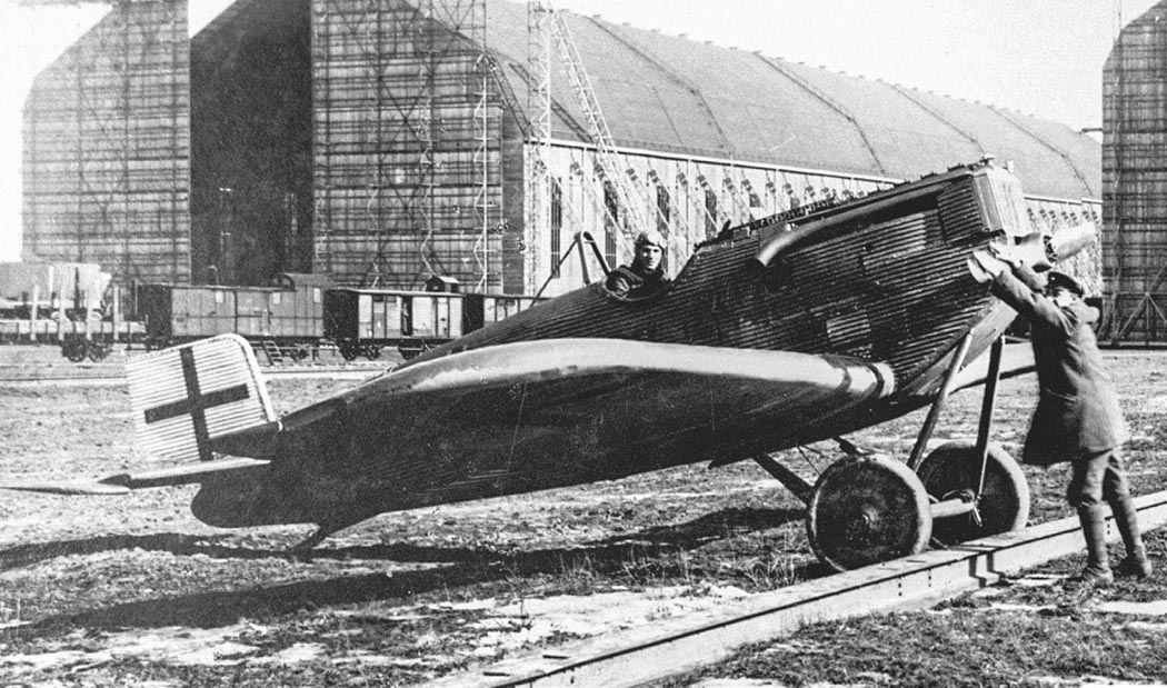 Junkers D.I fighter aircraft being handled by ground crew near hangars