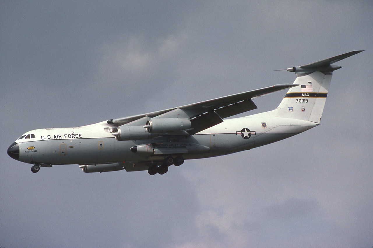 U.S. Air Force C-141 Starlifter marked MAC 70019 flying with gear partly extended.