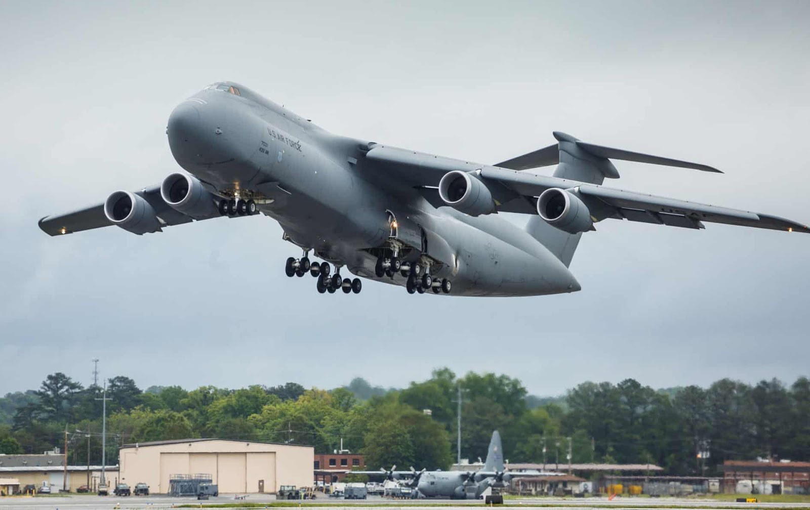 U.S. Air Force C-5 Galaxy climbing with landing gear extended.