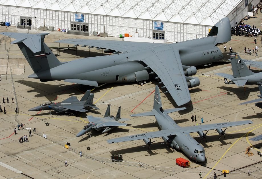 Overhead ramp view with a U.S. Air Force C-5 Galaxy and other aircraft around it.