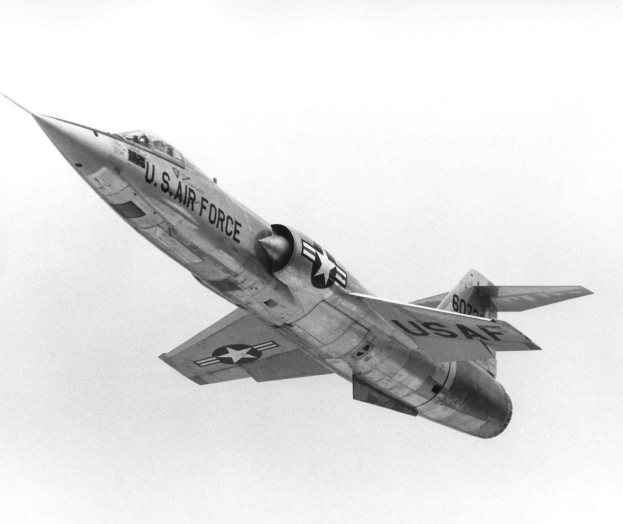 U.S. Air Force F-104 Starfighter climbing with underside markings visible.