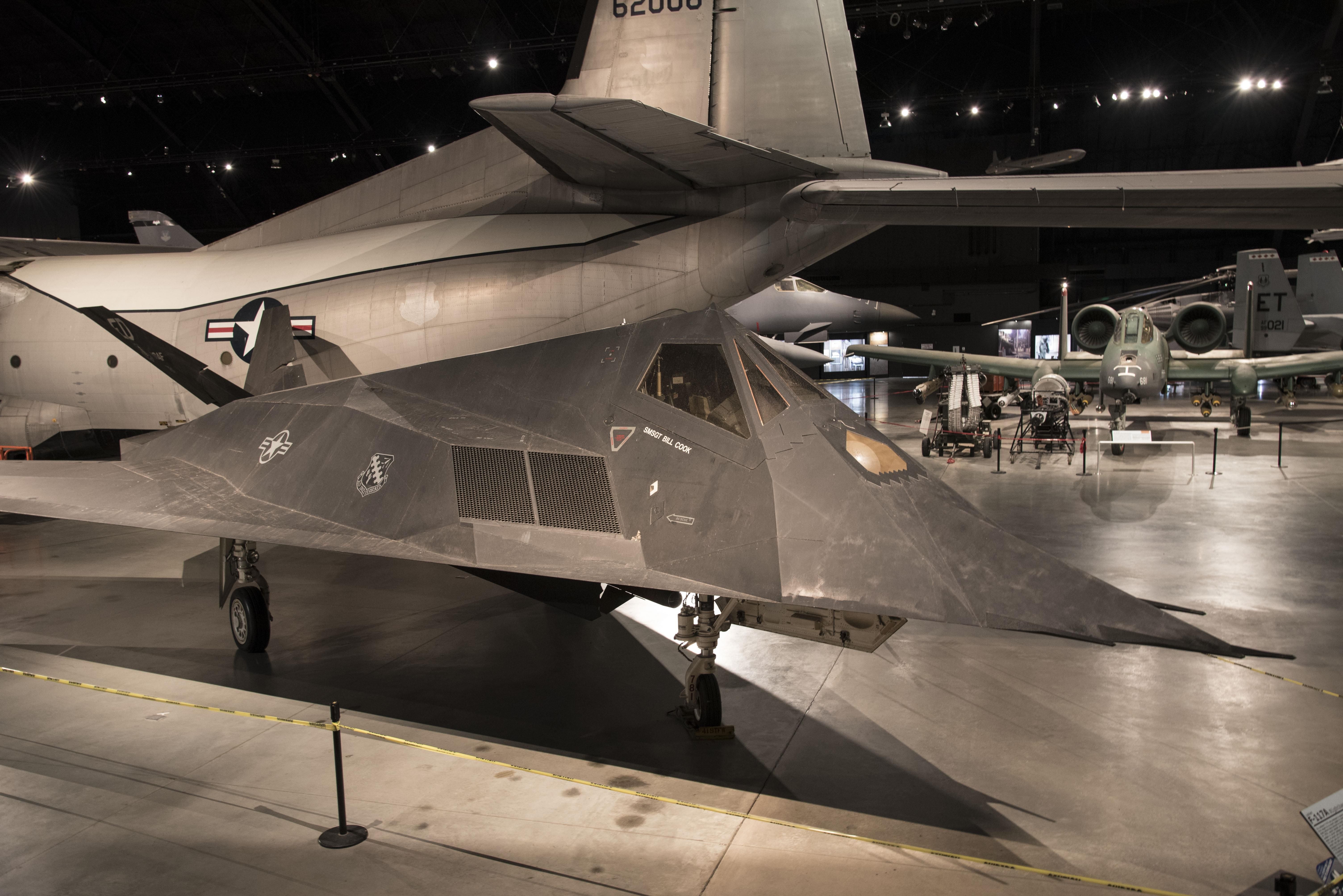 F-117 Nighthawk displayed indoors among other aircraft.