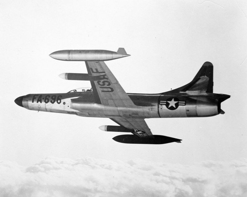 Black-and-white underside view of F-94 Starfire FA-690 in flight.