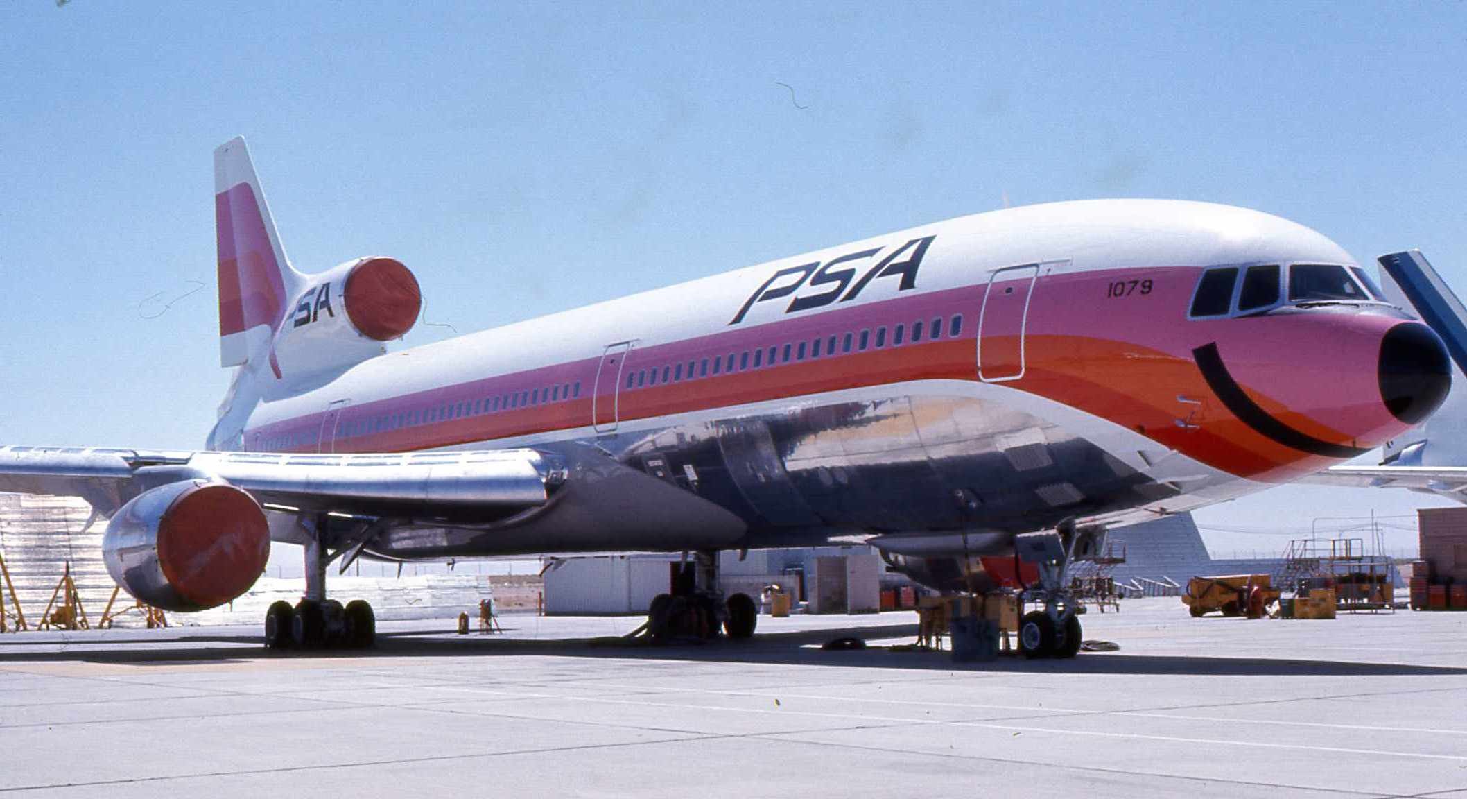 PSA Lockheed L-1011 TriStar parked on a ramp in red and orange livery.