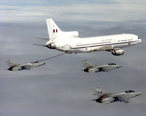 Royal Air Force Lockheed TriStar flying with four smaller aircraft.