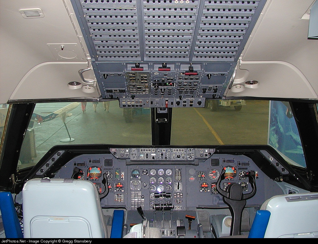 Lockheed L-1011 TriStar cockpit with overhead switches, instrument panel, and yokes.